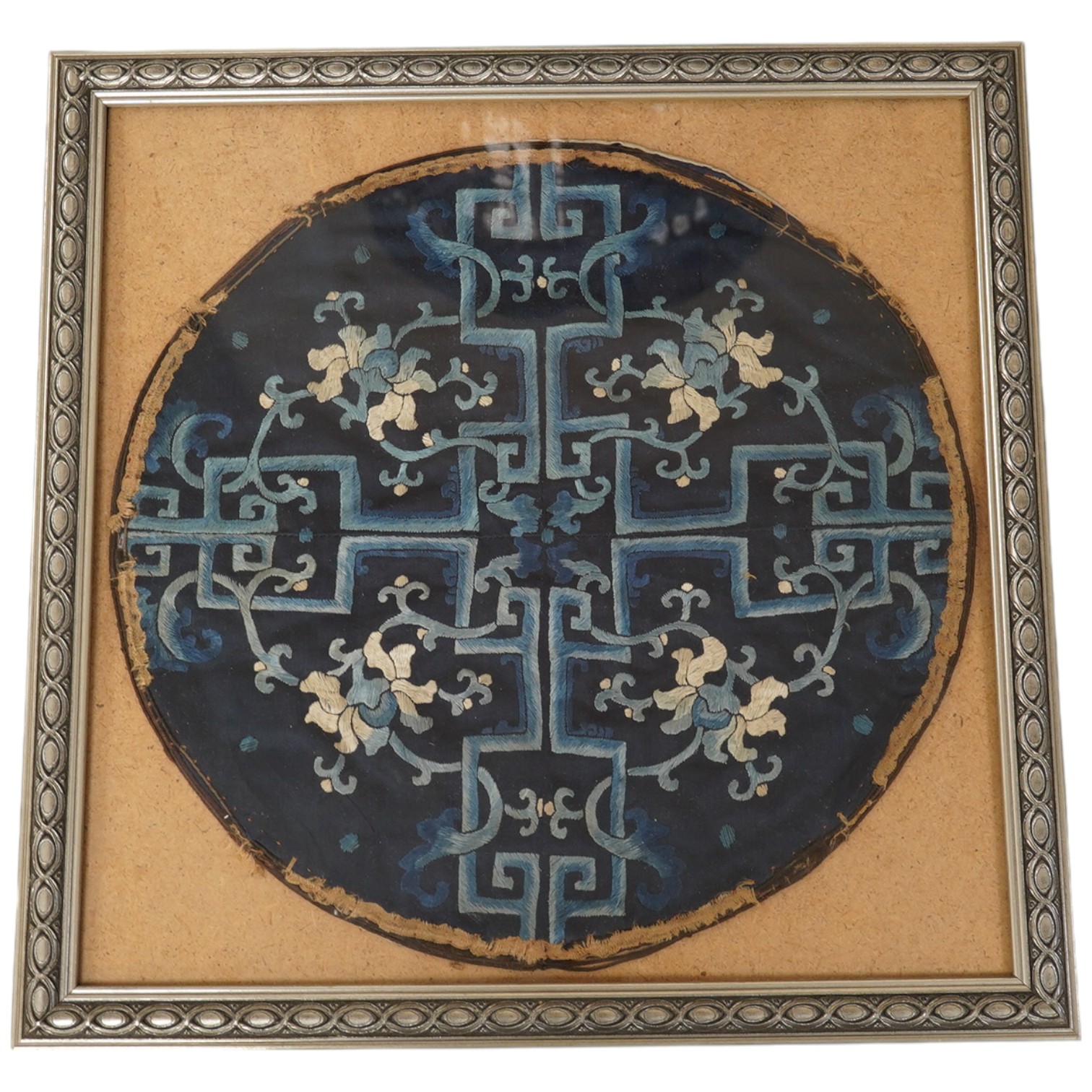 A framed 19th century Chinese silk embroidered floral roundel, possibly from a robe, 28cm diameter. Condition - main body of embroidery good, edging missing